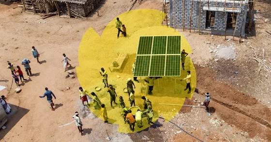 A solar panel being carried through a village