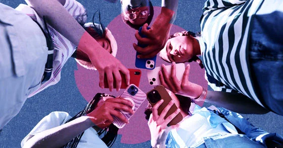 A group all looking down at their mobile phones