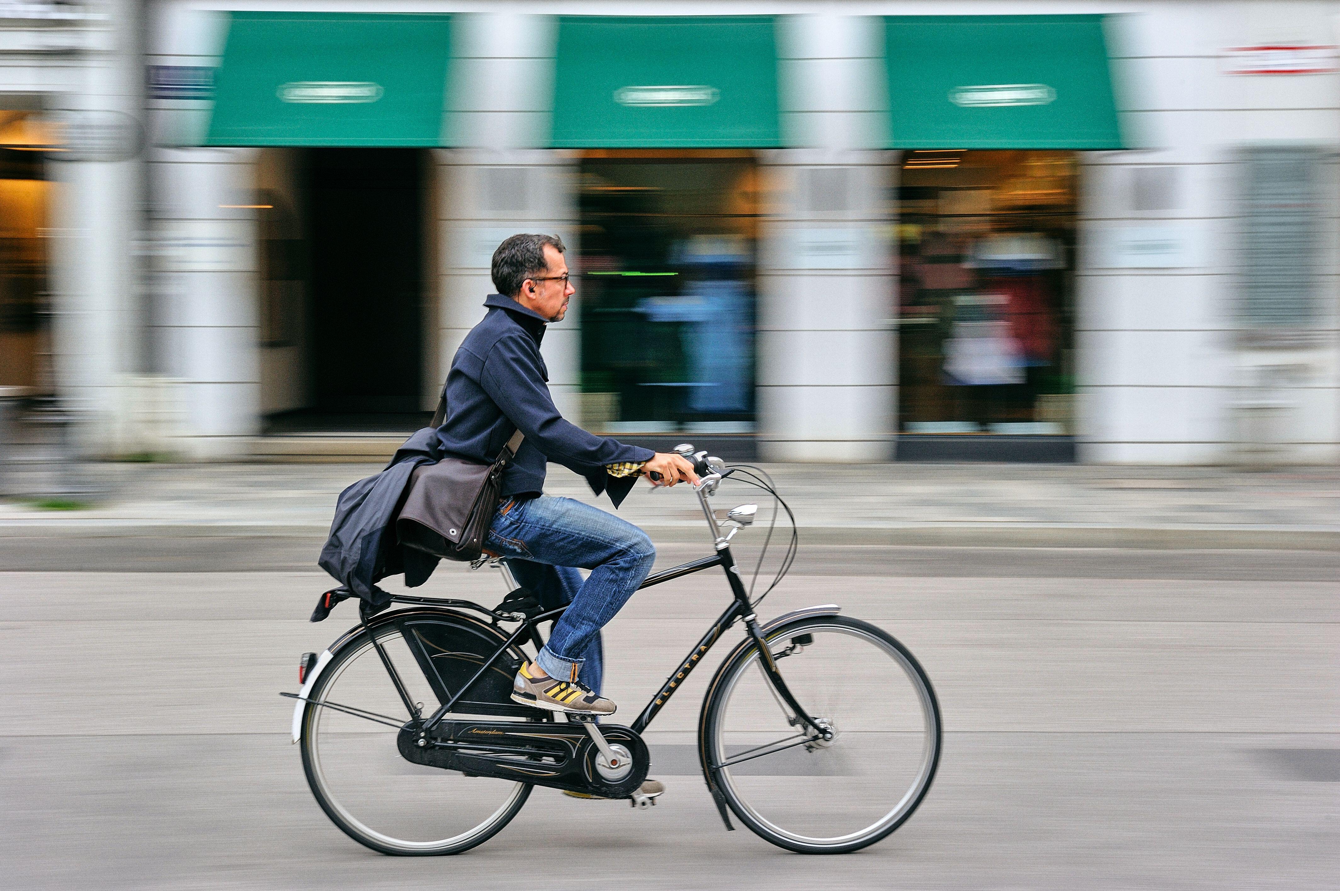 A man rides a bike through a German city