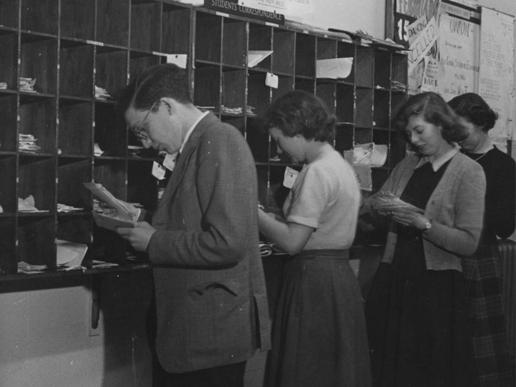 Students look at letters in their pigeon holes
