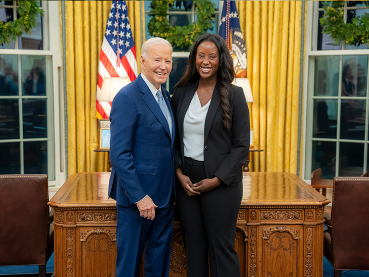 Oumou Ly stands with former President Biden in the White House
