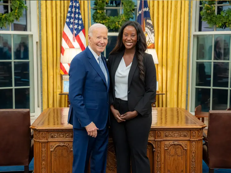 Oumou Ly stands with former President Biden in the White House