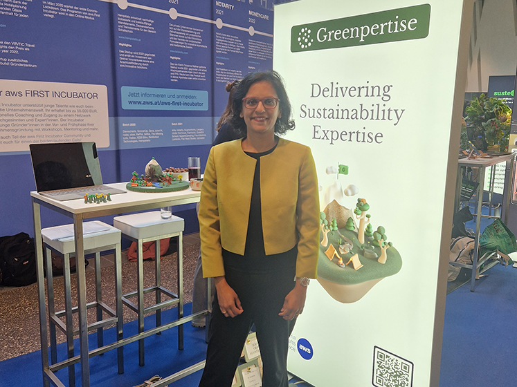 Darshii Waibel stands beside a display advertising Greenpertise