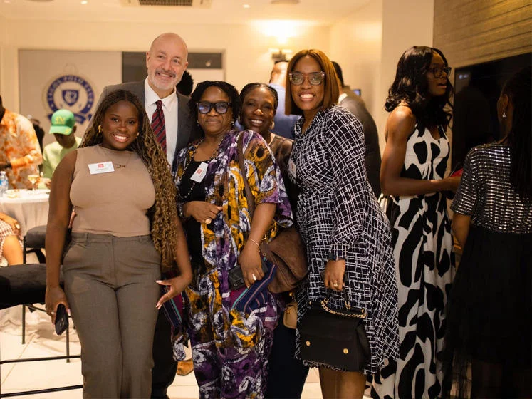 LSE President and Vice-Chancellor Larry Kramer stands with a group of LSE alumnae during an event in Lagos