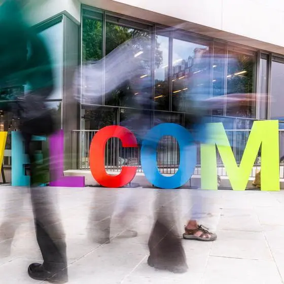Welcome sculpture with passersby