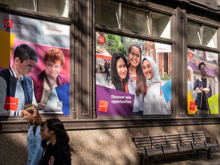 Students walking past LSE banners on campus
