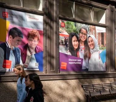 Students walking past LSE banners on campus