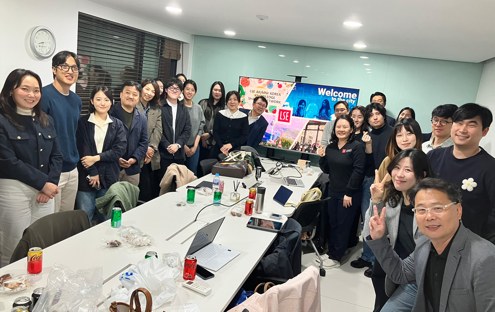 Alumni gather round a table during a knowledge exchange for Welcome to the City in Seoul