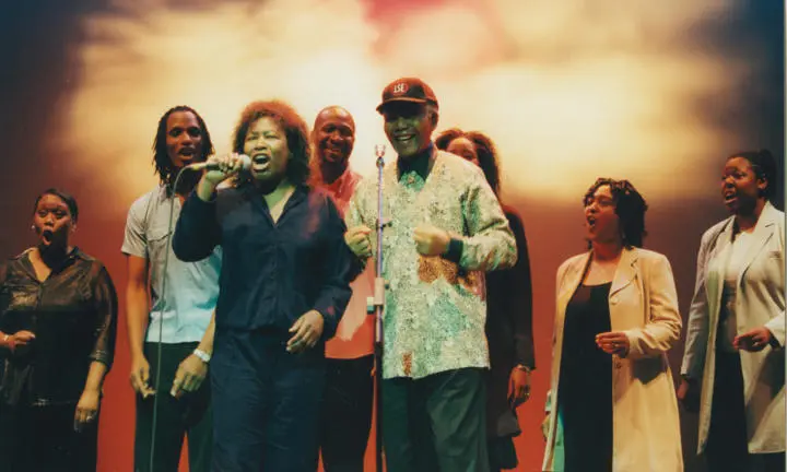 Joan Armatrading, Kingdom Chorus Singers and Nelson Mandela wearing LSE cap, 2000.