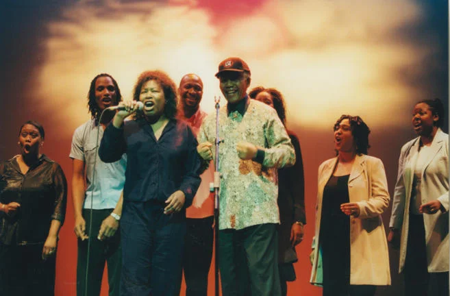 Joan Armatrading, Kingdom Chorus Singers and Nelson Mandela wearing LSE cap, 2000.