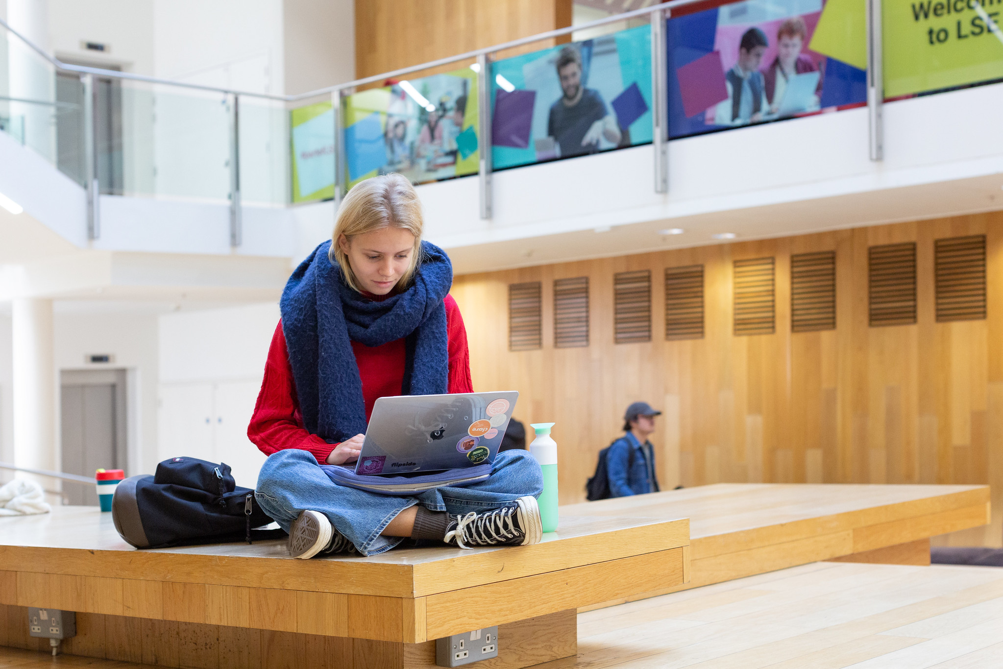 LSE student on laptop in the Cheng Kin Ku building