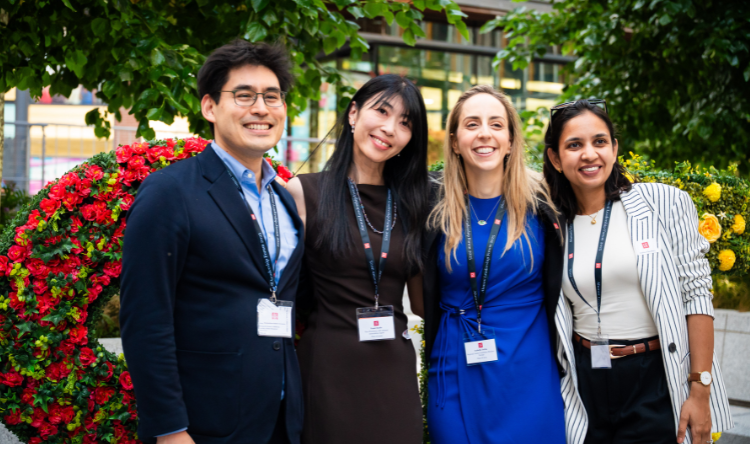 Four LSE alumni smiling on campus