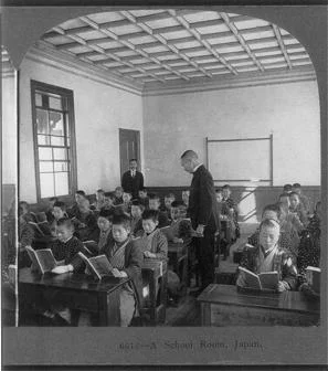 A school room showing children reading overseen by teachers, Japan