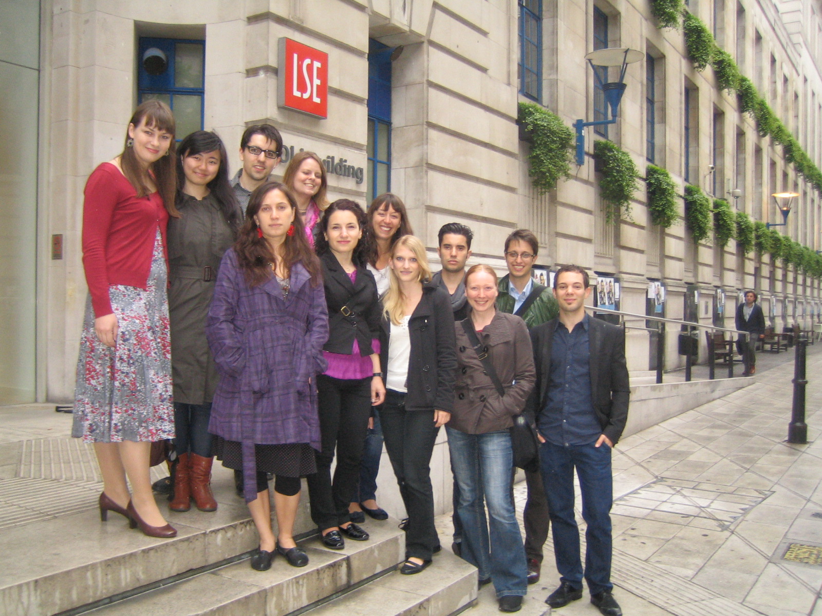 photo of methodology alumni stood on the stairs to the Old Building in 2011