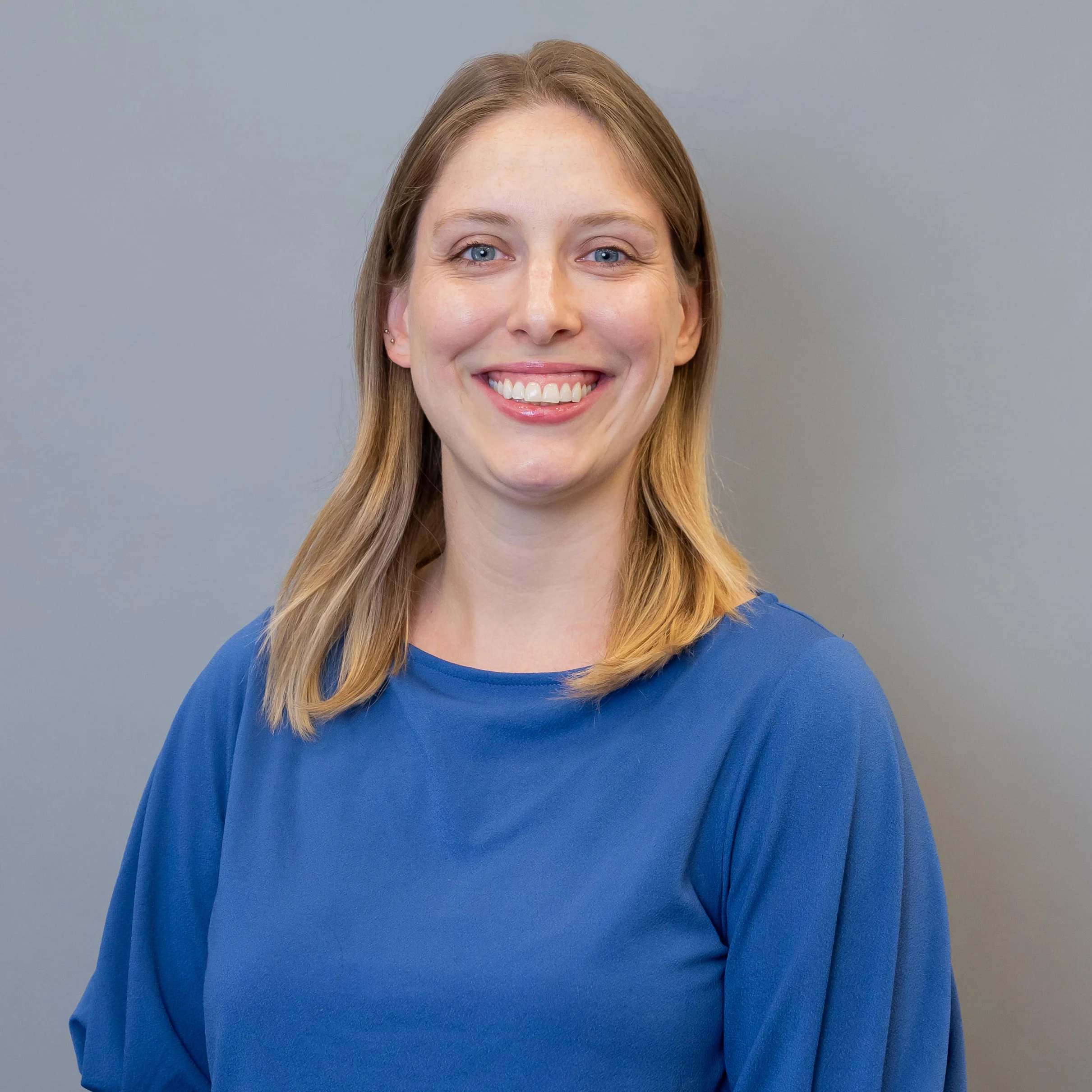 A smiling photo of Alexandra Bobak, she is wearing a blue top.