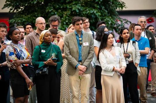 Group of LSE alumni listening outside