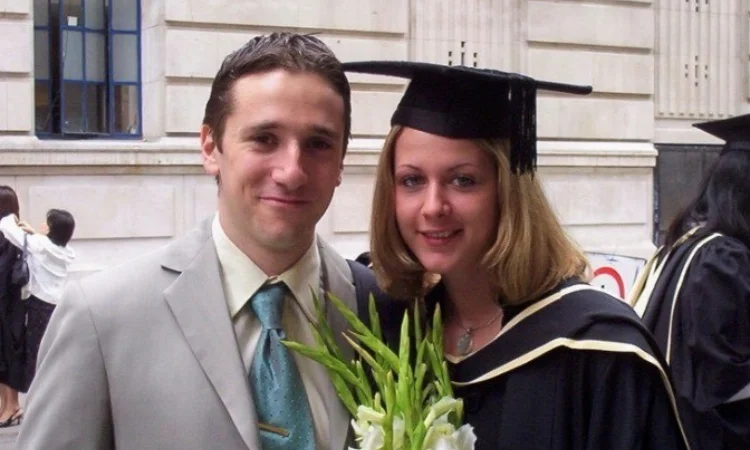 Alumni Michael and Ira Kollo with flowers at her graduation