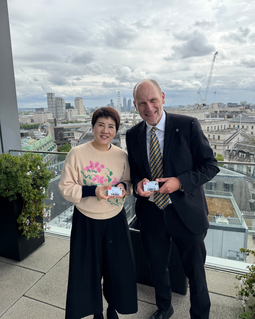 Angela Ng and Eric Neumayer smiling on terrace on LSE campus