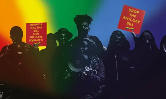 A crowd of people with protest signs that say 'Drop the anti-gay bill' and 'Uganda kill the bill'.