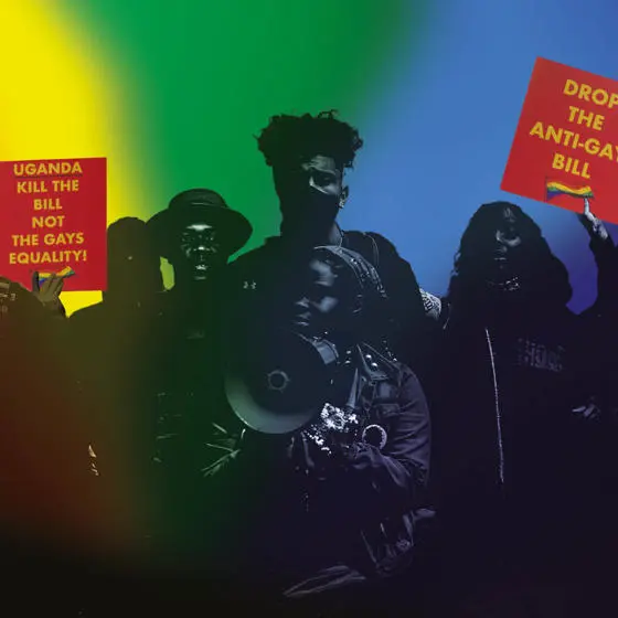 A crowd of people with protest signs that say 'Drop the anti-gay bill' and 'Uganda kill the bill'.
