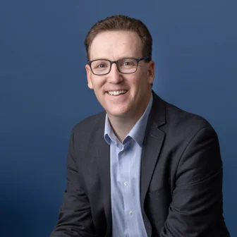 headshot of a man in a suit