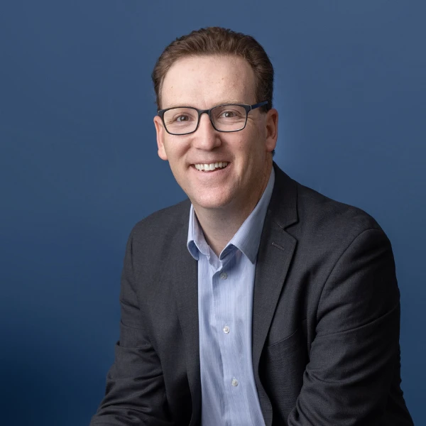 headshot of a man in a suit