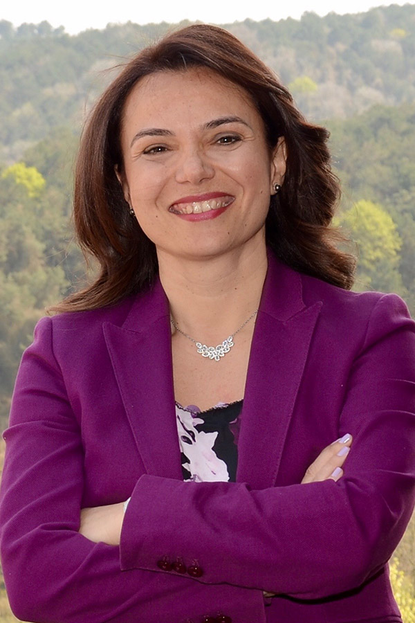 Woman smiling in a purple blazer