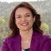 Woman smiling in a purple blazer