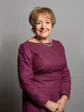 Headshot of Baroness Hodge with purple top and necklace