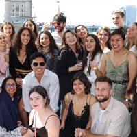 students on a boat party on the river thames