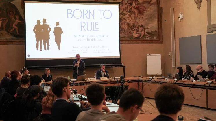 Academic seminar and book discussion hosted in a historic lecture hall, featuring researchers presenting work on social elites and British history.