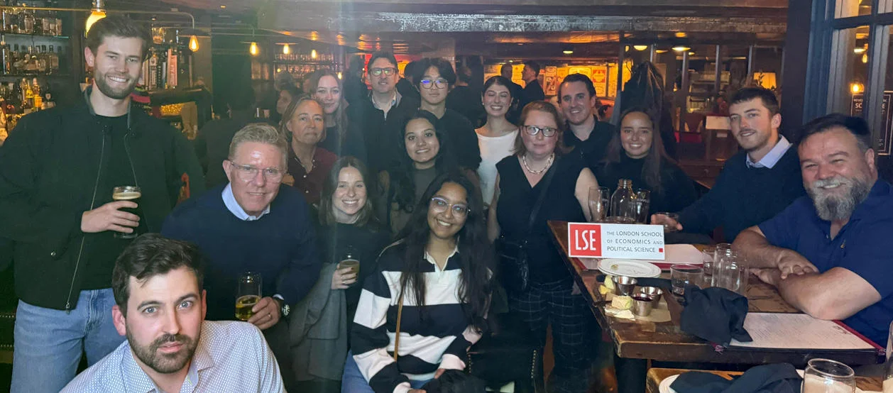 Boston alumni gather in a bar for Welcome to the City.