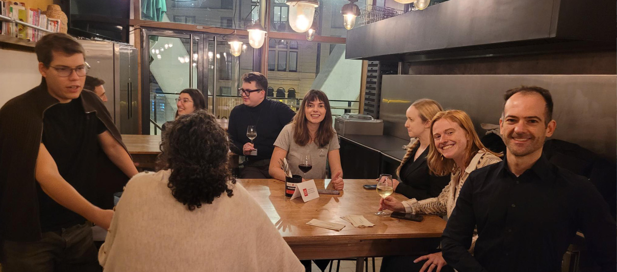 Alumni enjoy a drink in a bar as part of Welcome to the City Brussels.