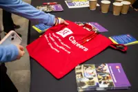 Red LSE Careers tote bag on a table