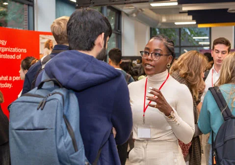 LSE Careers Fair featuring a Careers Advisor talking with a student