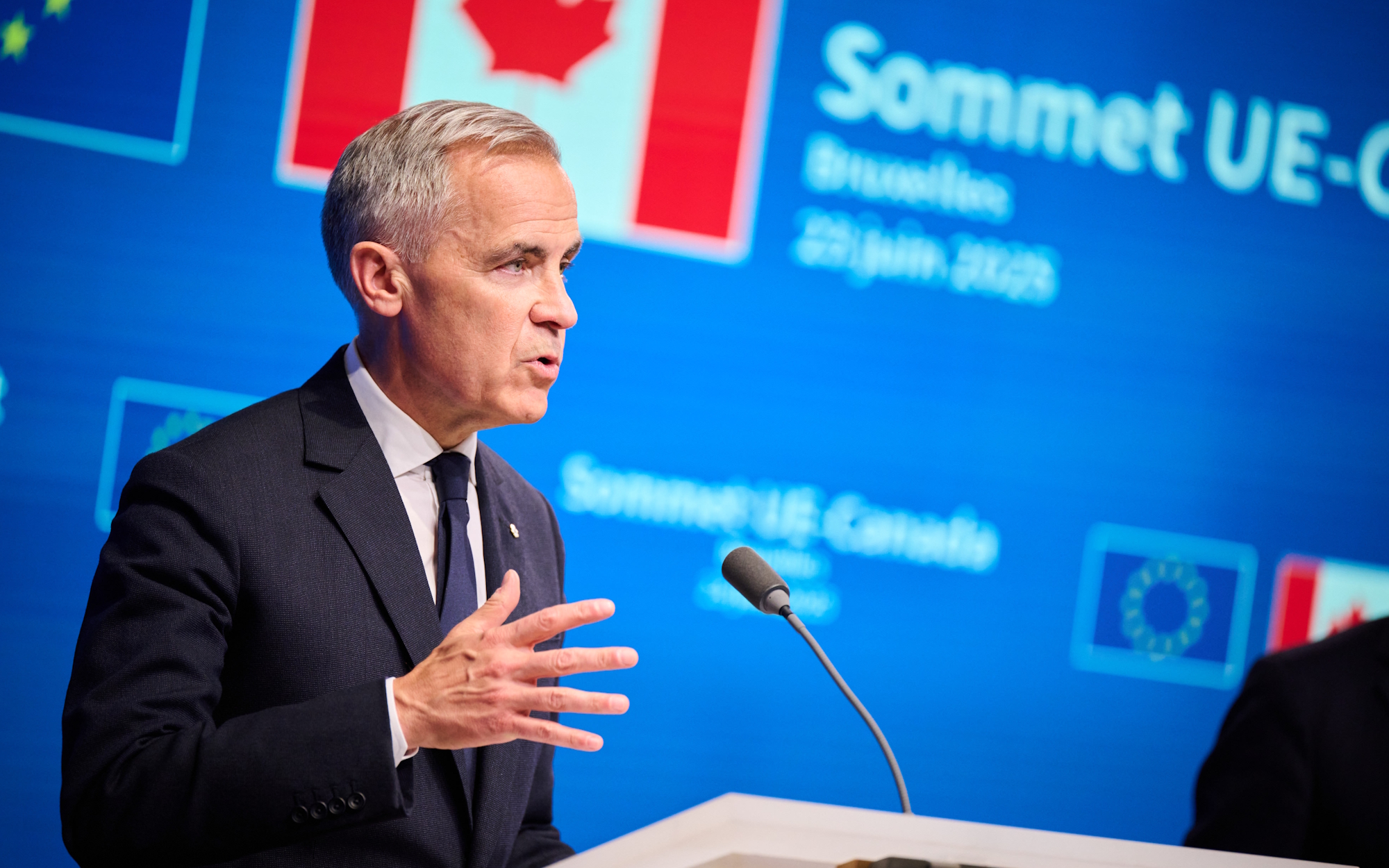 Mark Carney speaking at a podium