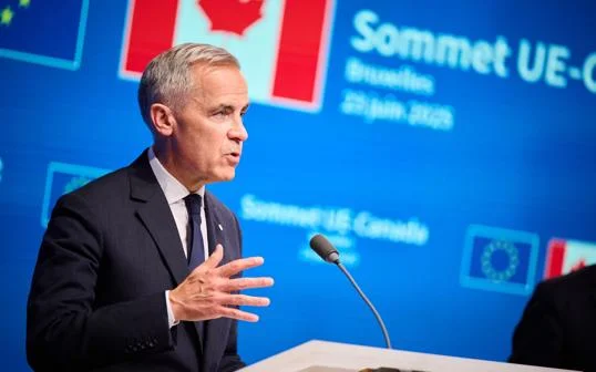 Mark Carney speaking at a podium