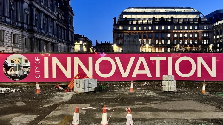Evening, Glasgow, large banner saying 'INNOVATION'.