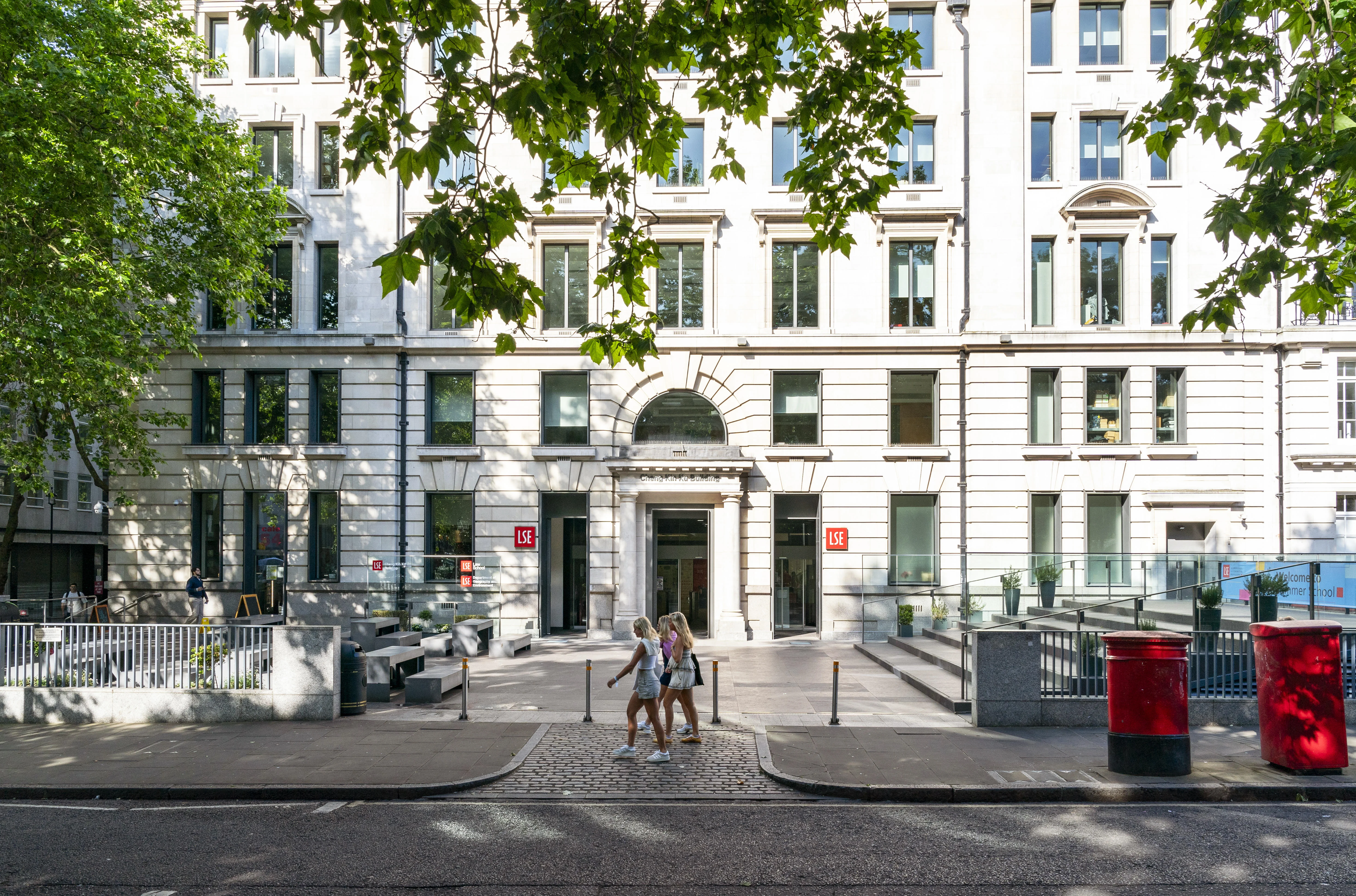 Cheng Kin Ku building in summer with students walking past.