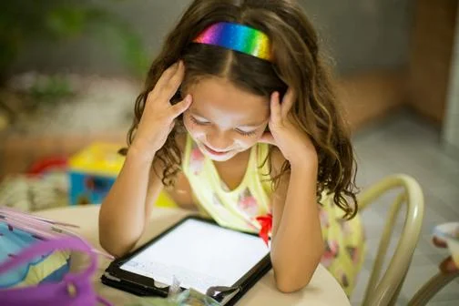 Young girl gazes at tablet