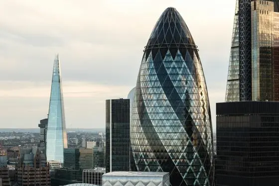 city of london skyline, with 30 St Mary Axe, know as the 'Gherkin', in the foreground and Shard in the background.
