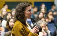 Young woman speaking into microphone