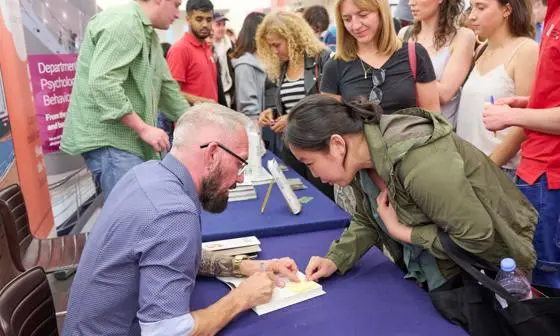 Paul Dolan signing books at Beliefism book launch