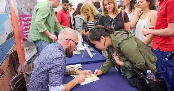 Paul Dolan signing books at Beliefism book launch