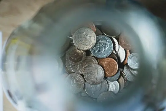 View looking down into a jar with coins in.