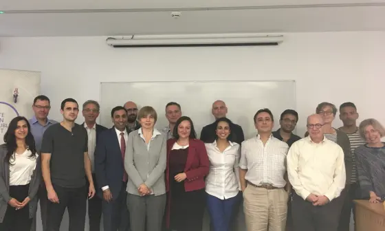 A group of academics stood in front of a blank whiteboard