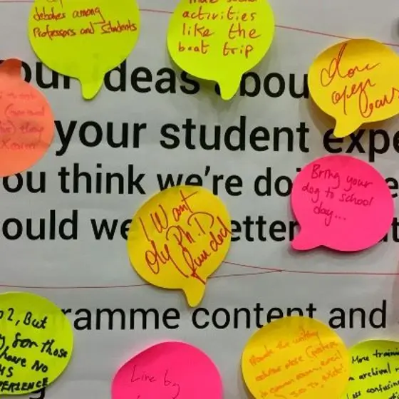 poster covered with postit notes with student feedback