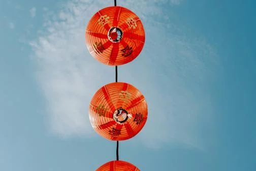 Red Chinese paper lanterns against blue sky