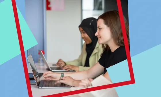 Two students looking at their laptop