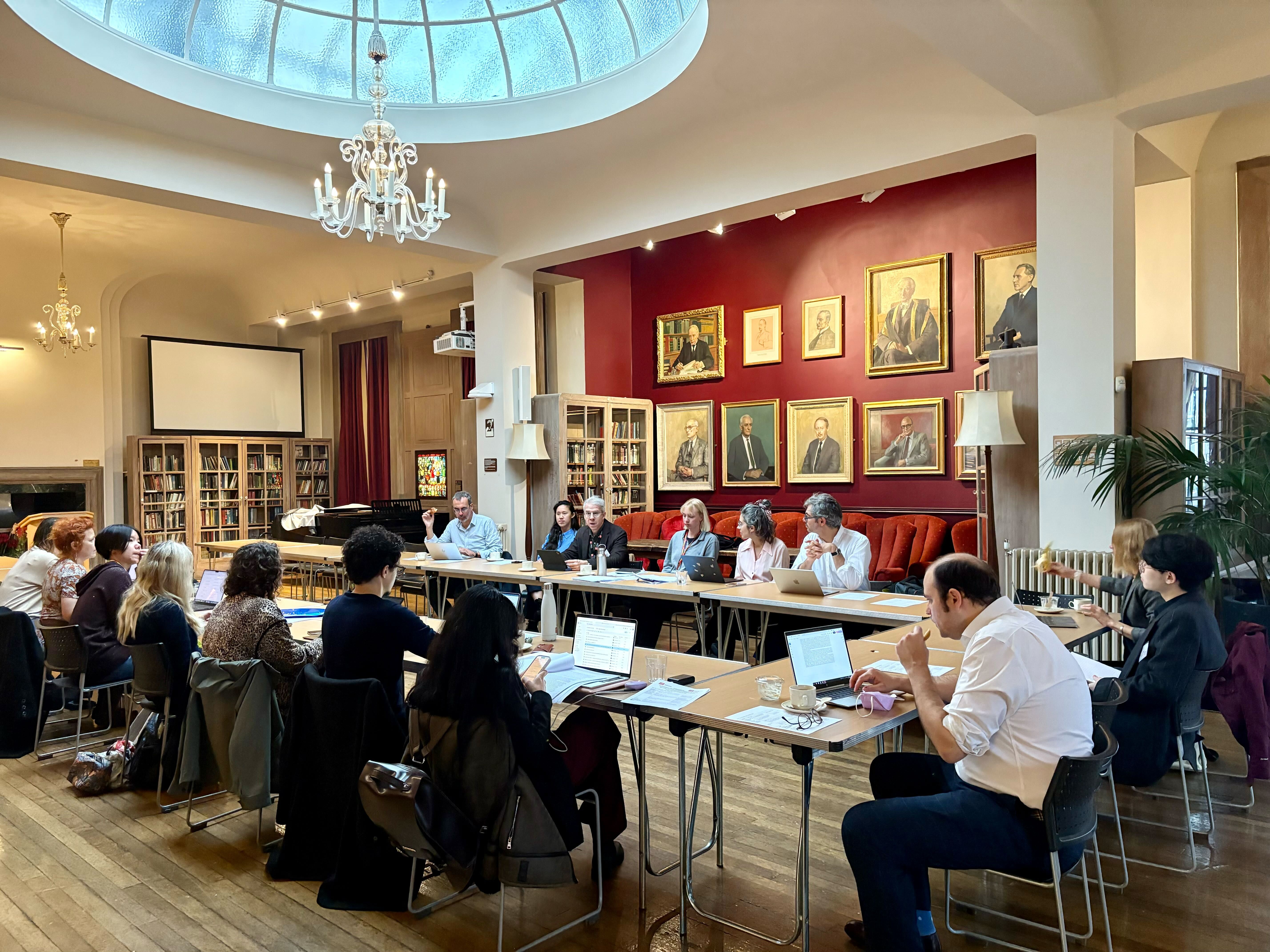 a group of people sat around a table in a large room
